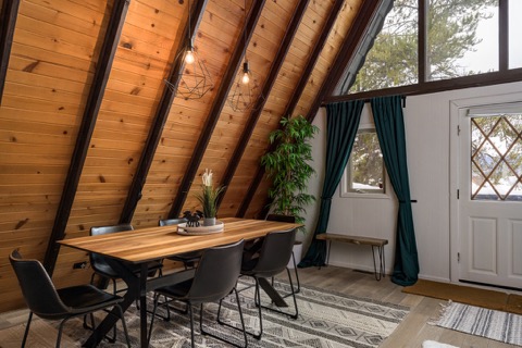 Dining table for six under the wood beams.