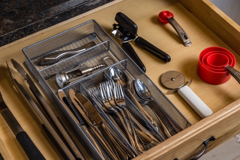 A kitchen drawer stocked with utensils and gadgets.