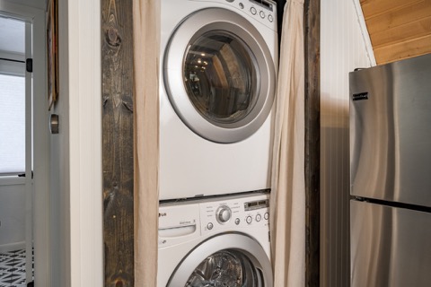 The stacked washer and dryer beside the kitchen.