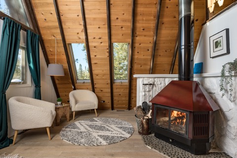 Armchairs pulled up to the lit wood stove.