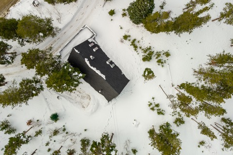 Straight-down aerial view of the roof in snow.