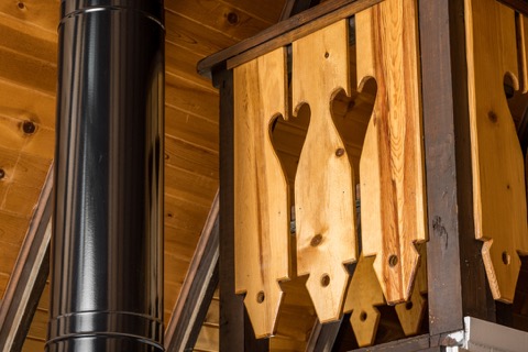 Heart-cut wood railing detail in the loft.