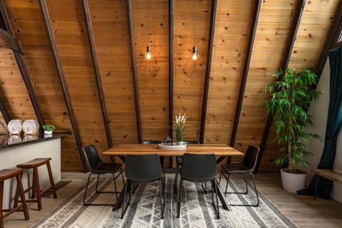 The dining table with pendant lights and stools.