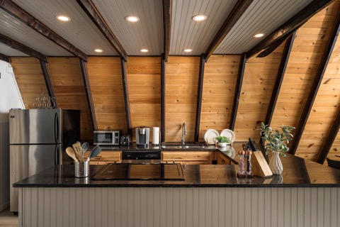 The kitchen counter and stainless fridge in view.