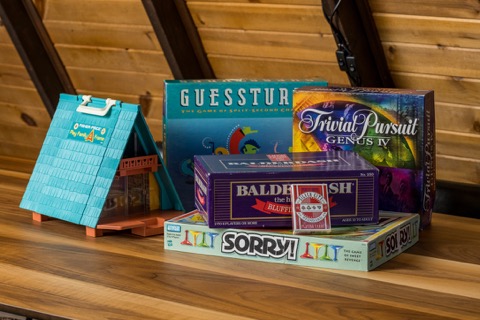 Board games stacked on the shelf.