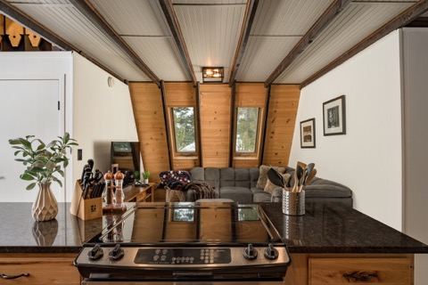 The stovetop with the living room beyond.