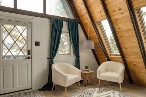 Armchairs near the front door's diamond-pane window.