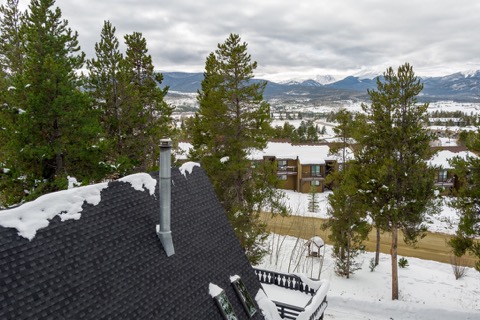 The chimney and rooftop overlooking the mountain valley.