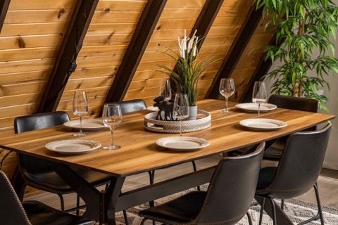The dining table set with plates and glasses.